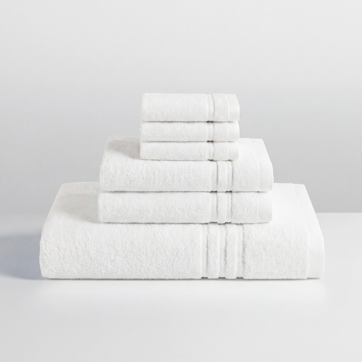The Hotel Standard towel gift set styled in a bathroom setting, white 700gsm cotton bath sheet and towels